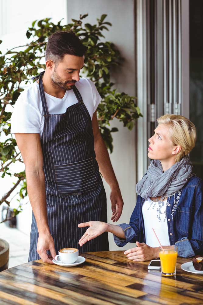 Picture of a woman complaining to her waiter.