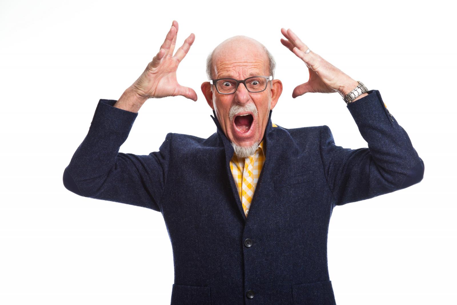 A picture of a man shouting angrily with his hands raised.